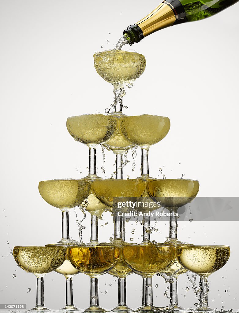 Champagne pouring into stacked glasses
