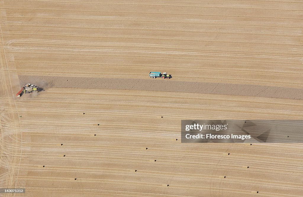 Aerial view of tractors at work in crop fields