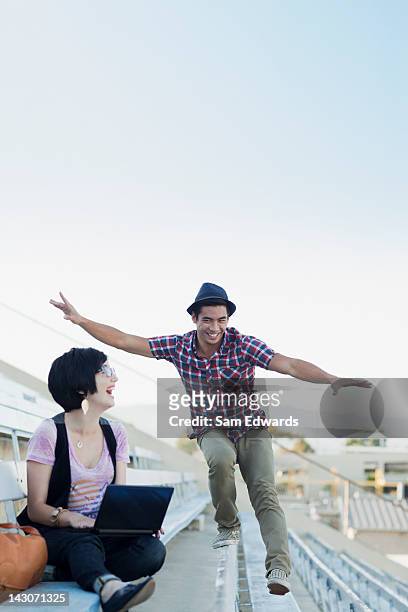 students relaxing on bleachers - action laptop stock pictures, royalty-free photos & images