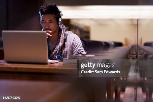 Student working on laptop in library Student working on laptop in library