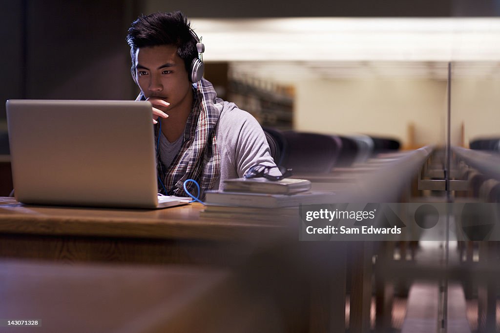 Student working on laptop in library