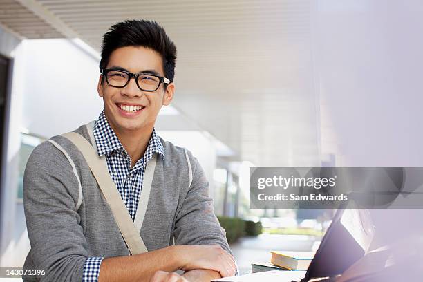 student smiling outdoors - asian guy background stock pictures, royalty-free photos & images