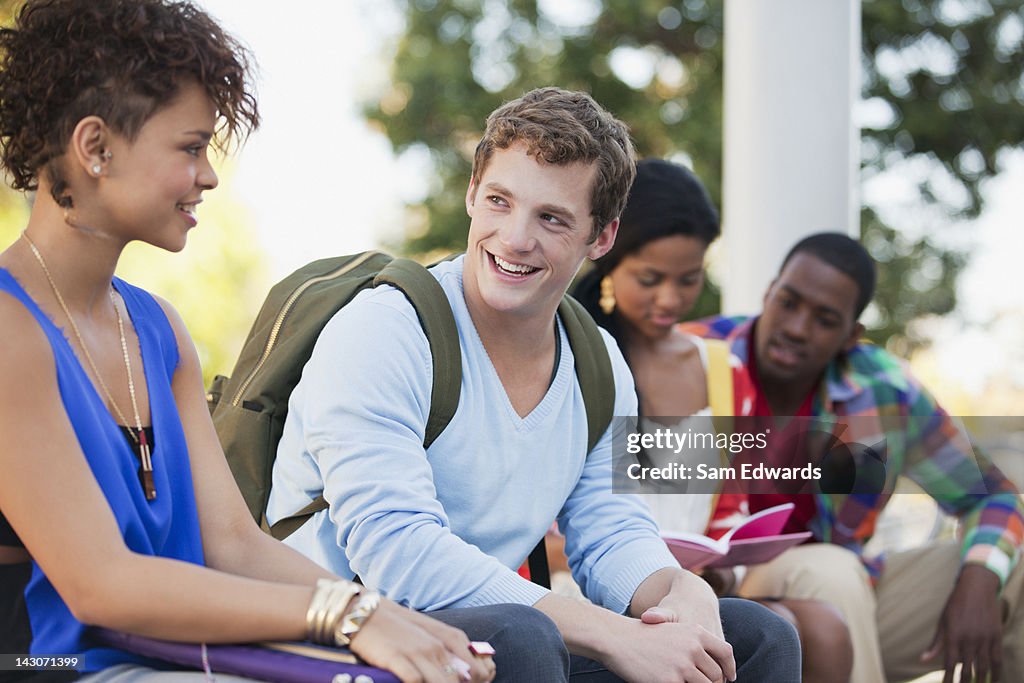 Smiling students talking outdoors