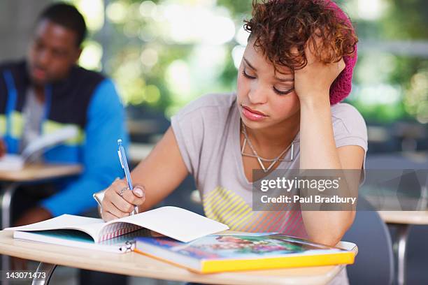 frustrated student at work in classroom - stressed student stock pictures, royalty-free photos & images