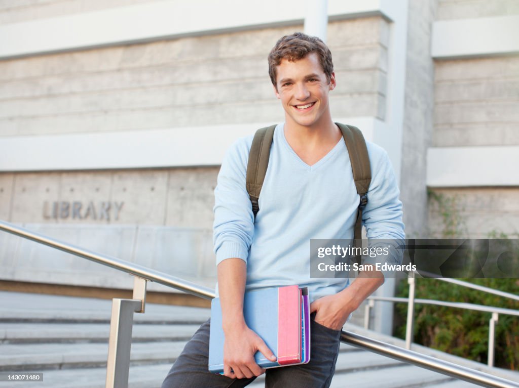 Student standing on steps outdoors