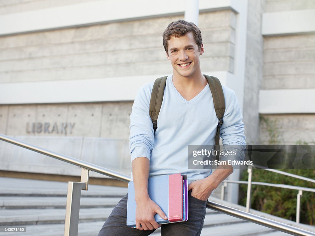 Student standing on steps outdoors