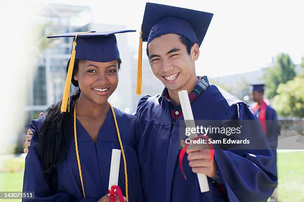 graduates with diplomas smiling together - holding two things stock pictures, royalty-free photos & images
