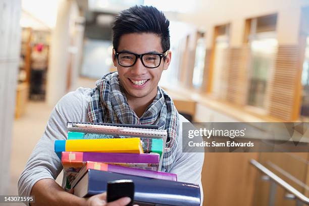 University Students Carrying Textbooks In Library Photos and Premium ...