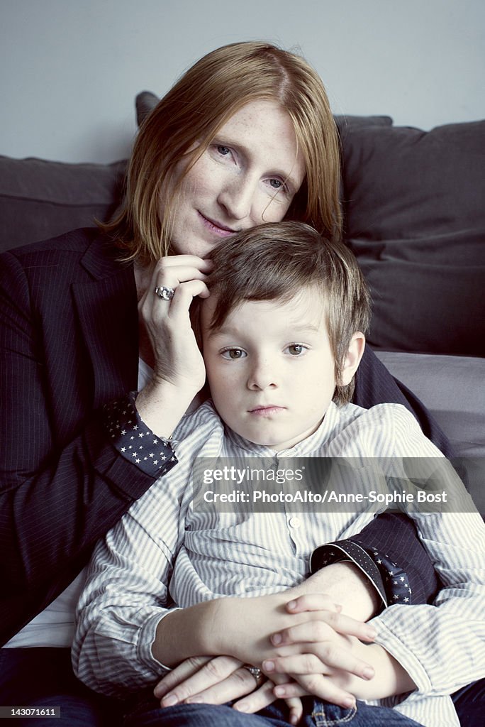 Mother holding son on her lap, portrait