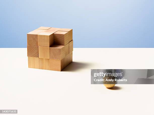 wooden ball with wooden cube - mismatch fotografías e imágenes de stock