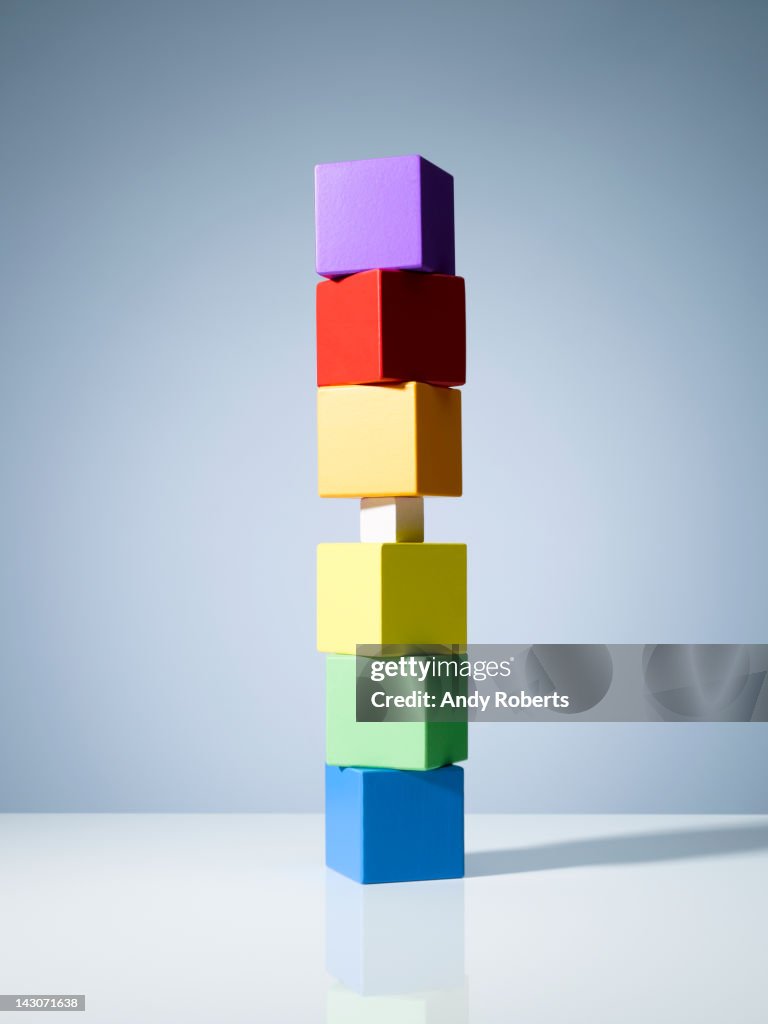 Tiny block in stack of colorful cubes