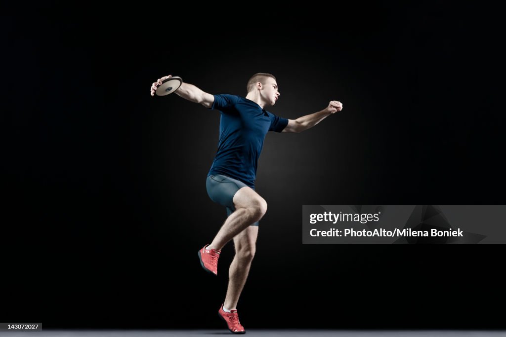 Male Athlete Throwing Discus High-Res Stock Photo - Getty Images