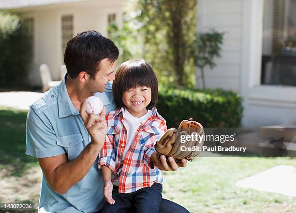 father teaching son to play baseball - bradbury house stock pictures, royalty-free photos & images