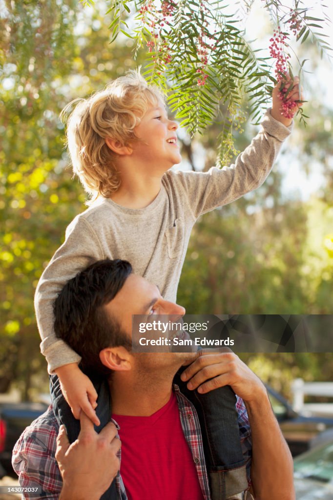 Father carrying son on shoulders