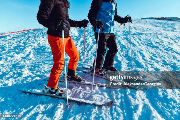 comparison of skiis by male and female - woman on ski lift stock pictures, royalty-free photos & images