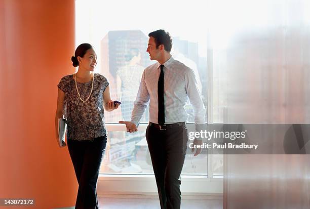 business people talking in office - business man woman walking stock pictures, royalty-free photos & images