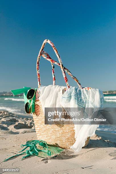 packed beach bag on beach - beach bag stock pictures, royalty-free photos & images