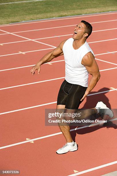 runner injured while running on track - injured runner stock pictures, royalty-free photos & images