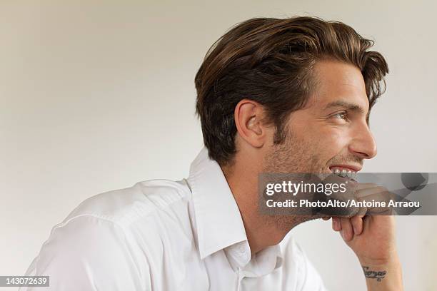 man looking away, smiling - man hand on chin stock pictures, royalty-free photos & images