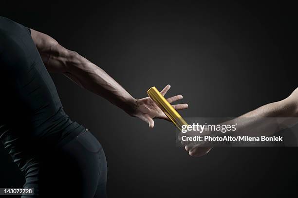 runners passing baton, cropped - estafette stockfoto's en -beelden