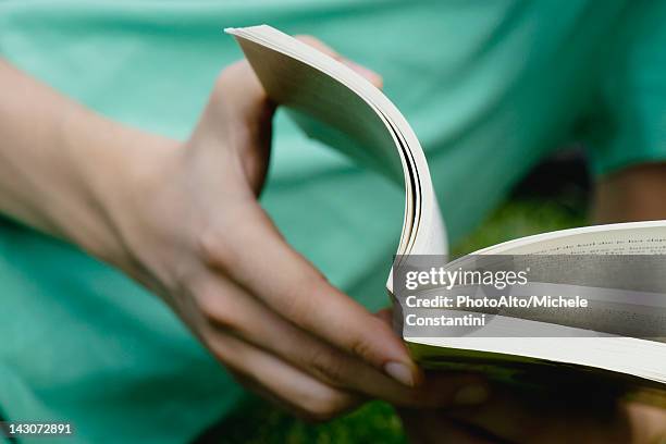 man reading book, close-up - livro de capa mole imagens e fotografias de stock