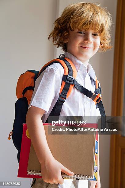 boy prepared for school, carrying backpack and notebooks - redhead boy fotografías e imágenes de stock