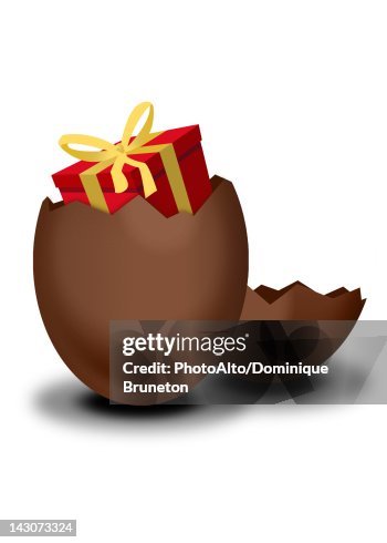 Chocolate Easter egg containing wrapped gift Chocolate Easter egg containing wrapped gift