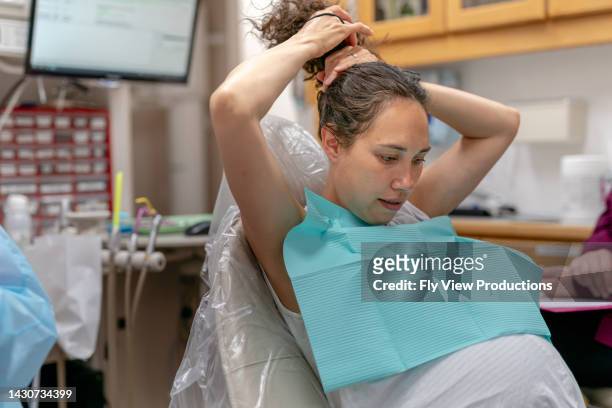 pregnant woman having dental work done - parodontitis stockfoto's en -beelden