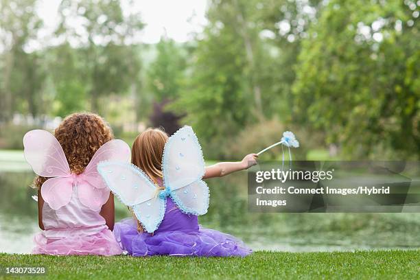 girls playing with fairy wings and wand - costume wing stock pictures, royalty-free photos & images