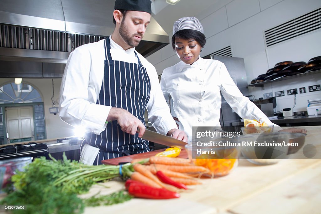 Teacher with student in cooking school