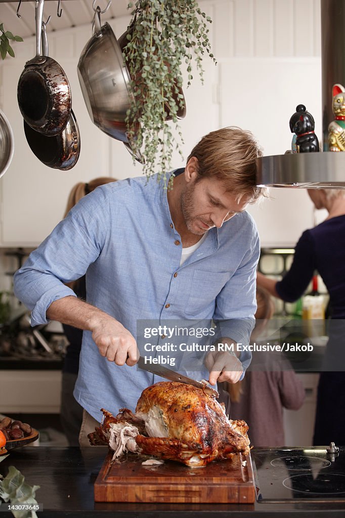 Man carving Thanksgiving turkey