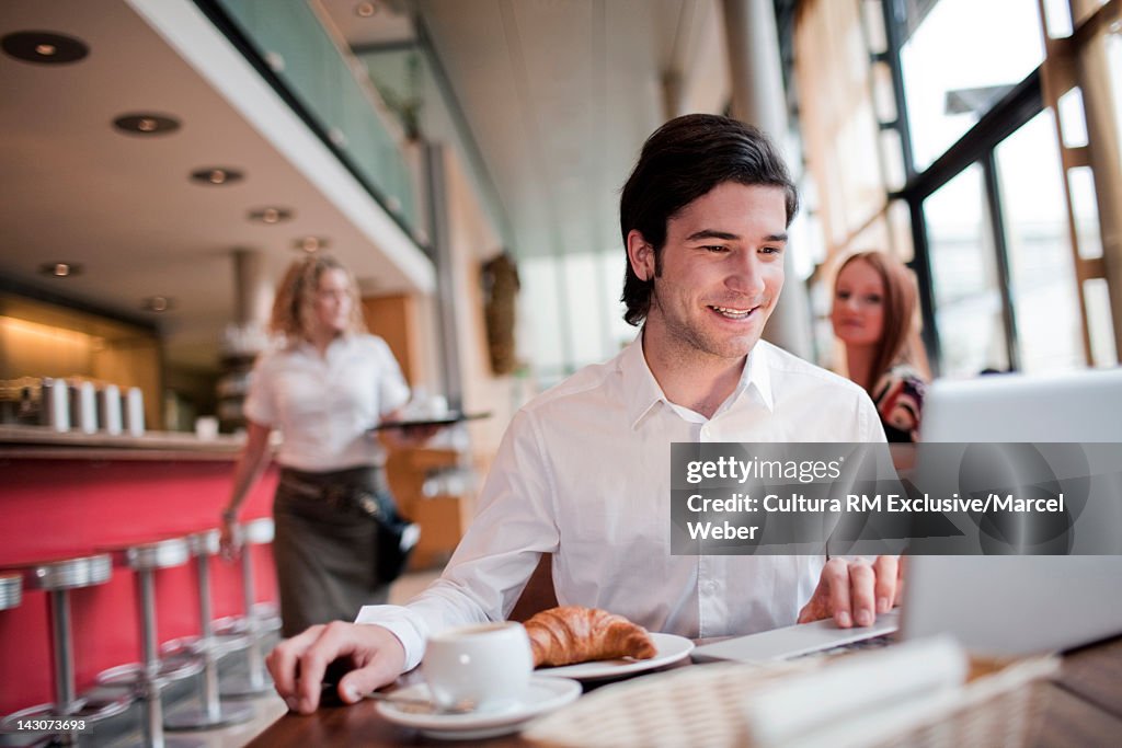 Businessman having breakfast in cafe