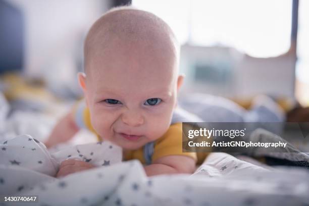 cute baby boy making funny expression to the camera. - funny baby photo 個照片及圖片檔