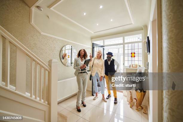 house hunting senior couple - model house stock pictures, royalty-free photos & images