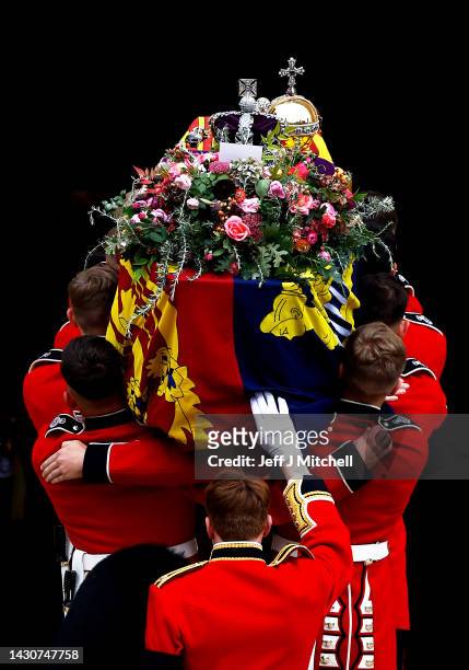 Pall bearers carry the coffin of Queen Elizabeth II with the Imperial State Crown resting on top into St. George's Chapel on September 19, 2022 in...
