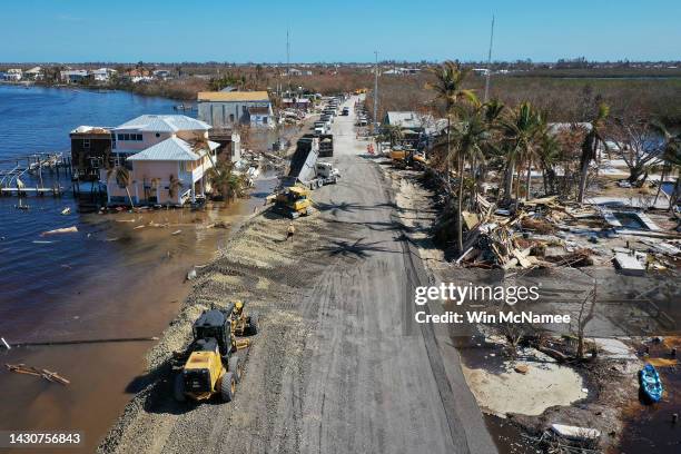 In this aerial view, construction crews work around the clock to make temporary repairs to a bridge on the island of Matlacha on October 05, 2022 in...