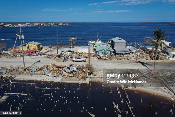 In this aerial view, construction crews work around the clock to make temporary repairs to a bridge on the island of Matlacha on October 05, 2022 in...