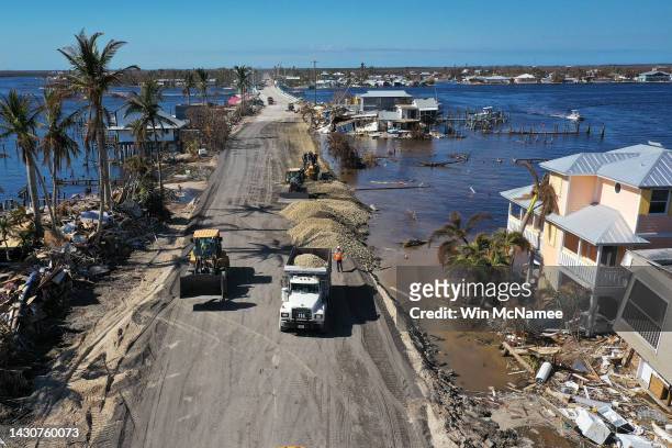 In this aerial view, construction crews work around the clock to make temporary repairs to a bridge on the island of Matlacha on October 05, 2022 in...