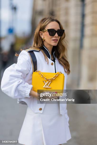 Alexandra Lapp wears Louis Vuitton cropped jacket, white mini skirt LV, Mango top in black, LV Twist MM bag in sunflower yellow, LV matchmake ankle...
