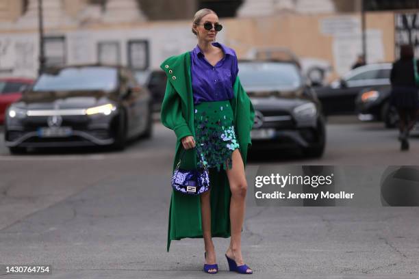Leonie Hanne seen wearing a purple fendi baguette bag, a green long coat and a purple sequin skirt, outside Zimmermann during Paris Fashion Week on...
