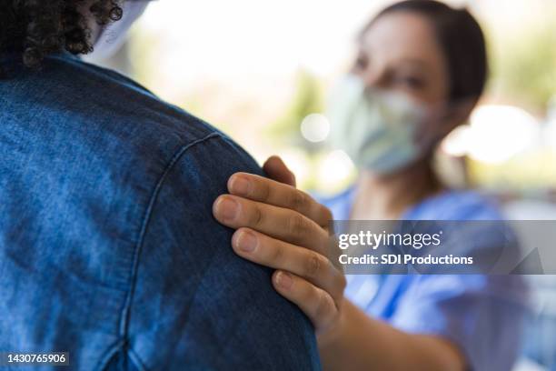 doctor comforts a patient - empathy stockfoto's en -beelden