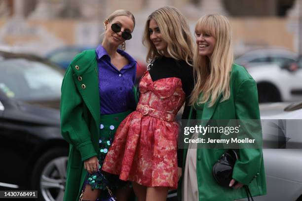 Leonie Hanne, Emili Sindlev and Jeanette Madsen seen wearing colourful looks, outside Zimmermann during Paris Fashion Week on October 03, 2022 in...