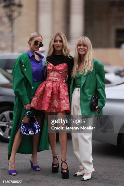 Leonie Hanne, Emili Sindlev and Jeanette Madsen seen wearing colourful looks, outside Zimmermann during Paris Fashion Week on October 03, 2022 in...