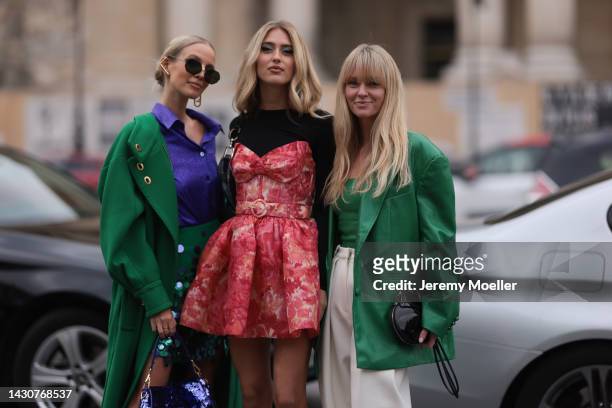 Leonie Hanne, Emili Sindlev and Jeanette Madsen seen wearing colourful looks, outside Zimmermann during Paris Fashion Week on October 03, 2022 in...