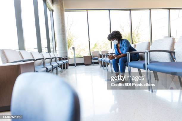 adult female patient waits - waiting room clinic stock pictures, royalty-free photos & images