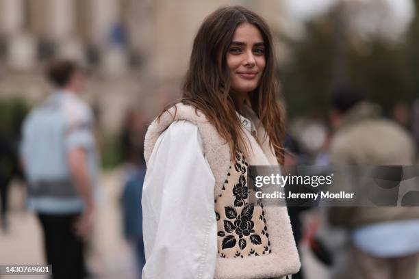 Taylor Hill seen wearing a white blouse with a black leather bag, outside Zimmermann during Paris Fashion Week on October 03, 2022 in Paris, France.