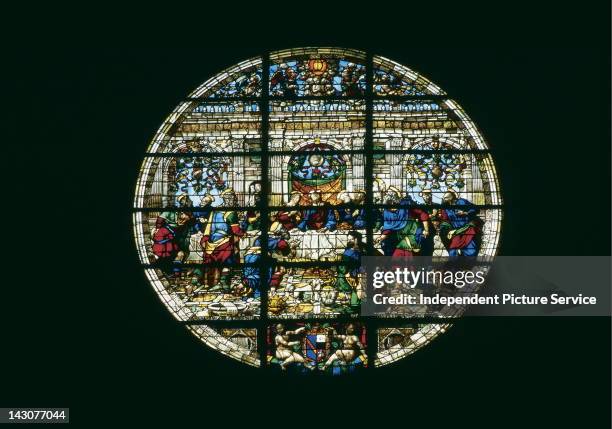 The Last Supper depicted in a 1549 circular stained glass window by Pastorino de' Pastorini. In the Siena Cathedral, Italy.
