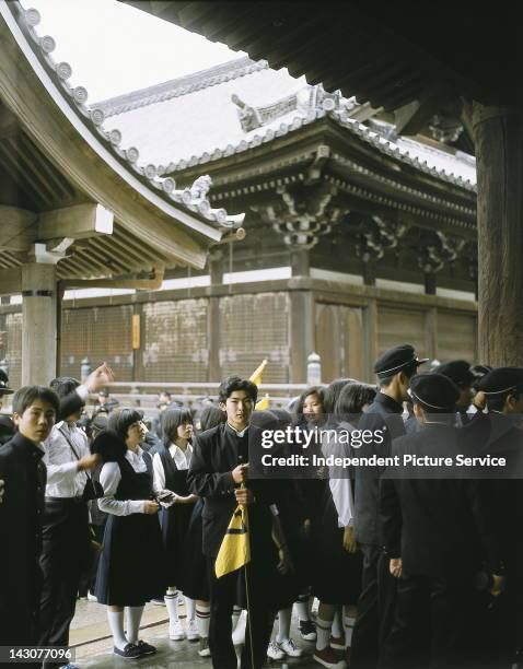 Tour group of schoolchildren at the Buddhist temple Kiyumizu-dera - Kyoto, Japan.