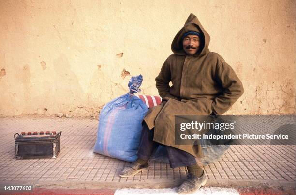 Moroccan wearing a traditional djellaba, Ouarzazate Province, Morocco.