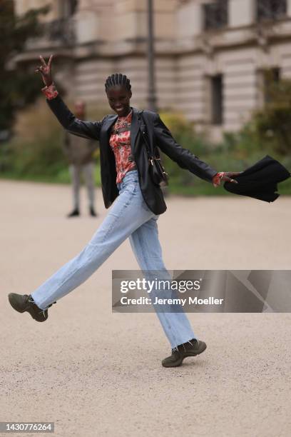 Fashion week guest seen wearing Louis Vuitton archlight sneaker, outside Zimmermann during Paris Fashion Week on October 03, 2022 in Paris, France.